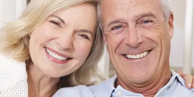 smiling couple with restored worn dentition,
