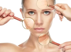 Woman with magnifying glasses held up to face showing skin texture, etc.,