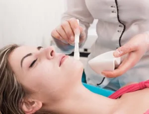 female patient having chemical peel applied by skincare specialist