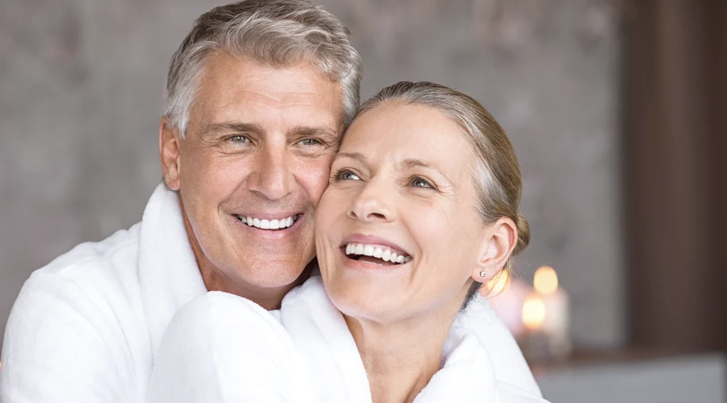 natural portrait, head and shoulders shot of attractive couple, with great nose shape and structure. Both smiling but not looking directly at camera.